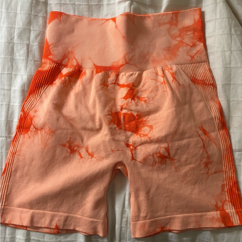 Orange tie-dye butt scrunch workout shorts